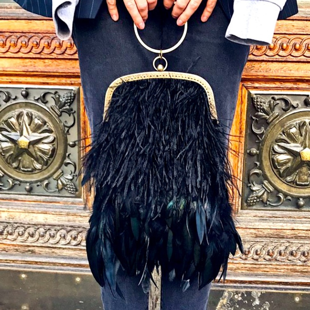 A bag made of ostrich and black cock feathers.
. New.